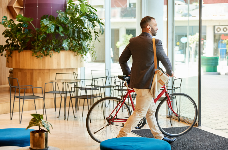 Businessman with bike going home after work