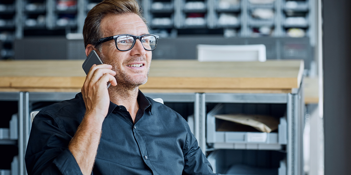 Man with glasses talking on the phone