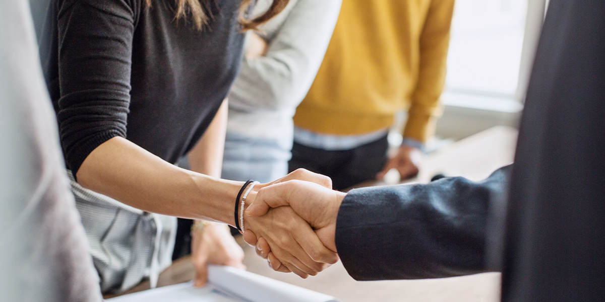 businesswoman and man shaking hands