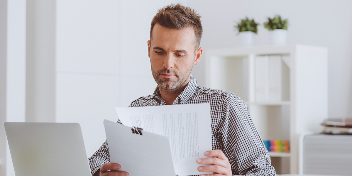 male mortgage broker reading through a contract