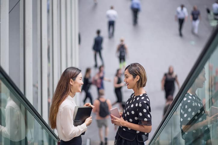 Two ladies on the escalator talking